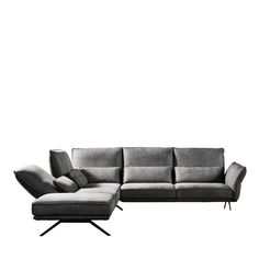 a gray couch and ottoman sitting on top of a white floor next to each other