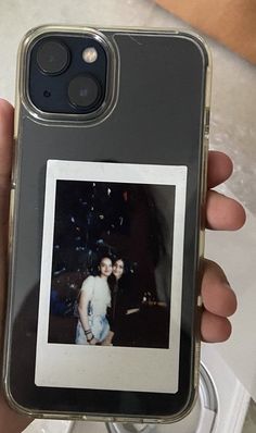 a person holding up an iphone case with a photo on the front and back cover