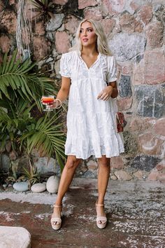 Chic White V-neck Tiered Dress, White V-neck Tiered Dress For Summer, White V-neck Tiered Casual Dress, White Flowy Tiered Dress For Vacation, Flowy White Tiered Dress For Vacation, Elegant White Mini Dress With Tassels, White Flowy Tiered Dress For Summer, Spring Day Out Dress With Tassels, White Flowy Tiered Summer Dress