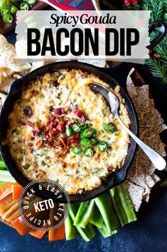 bacon dip in a cast iron skillet surrounded by vegetables and crackers with text overlay that reads spicy goula bacon dip