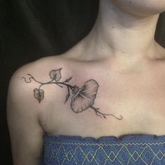 a woman with a flower tattoo on her chest