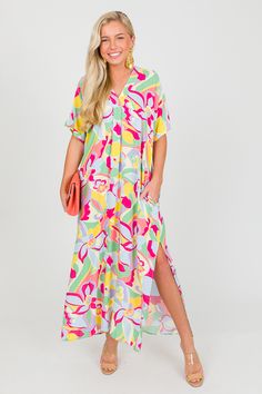 Step into the sunshine in this breezy, free spirited dress! The colors are so fun and fresh for summer. A pleat detail below the V neckline gives shape to the otherwise relaxed shape, and vented sides create plenty of movement. Flowy Midi Dress For Spring Beach Cover-up, Multicolor V-neck Beach Dress For Day Out, Multicolor Relaxed Fit V-neck Dress, Vibrant V-neck Maxi Dress For Spring, Flowy V-neck Beach Dress With Tropical Print, Breezy V-neck Beach Dress For Summer Outings, Colorful V-neck Vacation Dress, Summer V-neck Relaxed Fit Dress, Breezy Short Sleeve Vacation Dress