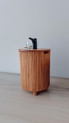 a small wooden table with a camera on it's top and an object in the middle