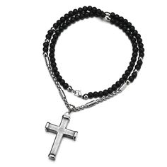 The simple stainless steel cross pendant of this accessory has a checker patterned ridge carved symmetrically across the entire silver pendant. The ends of each cross leg are studded with a smoothened protective layer. While the cross may offer a simplistic design, the Innovato Design chain necklace is made from a stainless steel chain with matte black beads throughout. The beads follow a rosary pattern where clusters of 10 beads are separated by an elongated silver bead. This gives the piece an added purpose of being a rosary.  Product highlights:    Simple Ribbed Cross Pendant (Size: 32 mm x 45 mm)  Made from durable Stainless Steel Silver  Long and Aesthetic Beaded Metal Necklace (Length: 23.62") Rosary Pattern, Black Beaded Necklace, Stainless Steel Cross Pendant, Steel Cross, Black Bead Necklace, Simplistic Design, Checkered Pattern, Metal Necklaces, The Cross