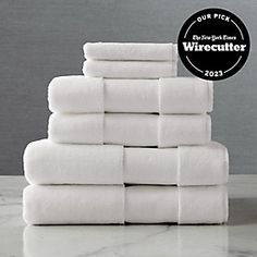 a stack of white towels sitting on top of a counter