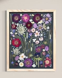 a painting with flowers in it hanging on the wall