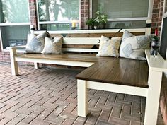 a wooden bench sitting on top of a brick patio