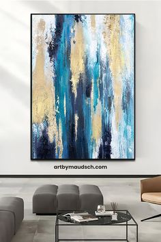 an abstract painting hangs on the wall above a coffee table in a modern living room