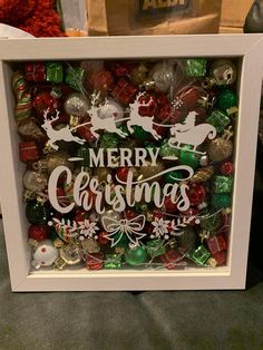 a white frame filled with christmas ornaments