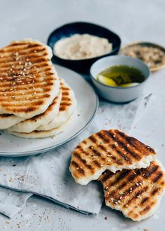 some food is sitting on a plate and ready to be eaten with sauces in the background