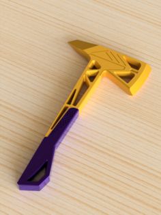 a yellow and purple plastic object sitting on top of a wooden table