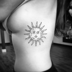 a woman with a sun tattoo on her chest