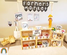 a store display with lots of items on the shelves and in front of it is a sign that says farmer's market