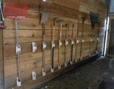 there are many different types of tools on the wall in this room with wood paneling