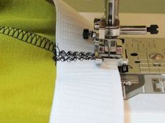 the sewing machine is working on the fabric that has been stitched together with it's needle