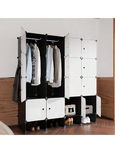 an open wardrobe with clothes hanging on it