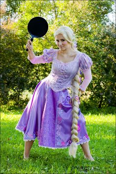 a woman in a purple dress holding a paddle