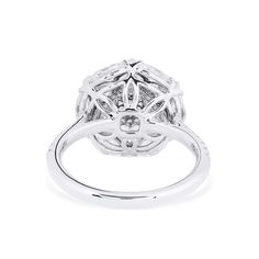 a white gold ring with diamonds on the top and bottom, set in 18k white gold