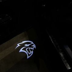 a close up of a black piano with a blue and white logo on the side