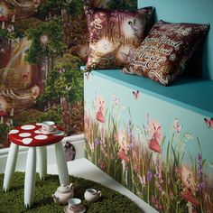 a room with green carpet and colorful wallpaper