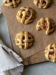 apple pie cookies sitting on top of a wooden cutting board