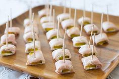 small appetizers with toothpicks on a wooden tray