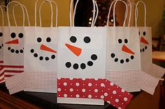 paper bags with snowmen on them sitting on a table