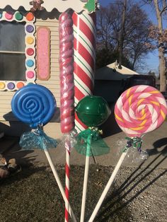 some candy lollipops are in front of a house