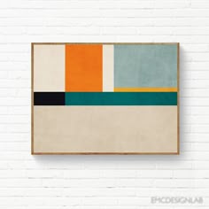 an abstract painting hanging on the wall in front of a white brick wall with a wooden frame