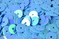 many blue and green buttons are scattered together