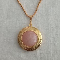 "Photo necklace for women.  Rounded picture locket with rose quartz cabochon.  Photo locket necklace. Vintage locket. Picture necklace gift   This necklace measures 29\" inches in length Fit 20 mm I include always a free surprise gift with every order All items are wrapped individually in a gift box Shipment arrives in 4 week by registered mail Contact me with any questions or requests, I'd be happy to help" Spiritual Rose Gold Locket Necklace, Gold Rose Quartz Round Pendant Jewelry, Pink Medallion Jewelry As A Gift, Pink Medallion Jewelry Gift, Pink Medallion Jewelry For Gifts, Rose Gold Pendant Locket Necklace, Rose Quartz Round Pendant Jewelry Gift, Round Rose Quartz Pendant Jewelry Gift, Gold Rose Quartz Round Pendant Necklace