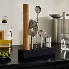 kitchen utensils and olives sit on a counter