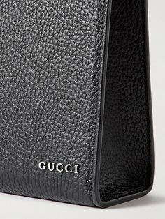 Gucci's pouch has been made in Italy from full-grain leather and discreetly detailed with a silver-tone logo. It opens to a canvas-lined interior with handy slip pockets to organise your essentials. Gucci Leather Pouch Bag, Classic Gucci Wallet For Travel, Classic Gucci Travel Wallet, Gucci Formal Pouch Shoulder Bag, Designer Pebbled Leather Shoulder Bag, Formal Gucci Pouch Shoulder Bag, Designer Black Leather Pouch, Black Textured Leather Pouch, Modern Business Pouch With Dust Bag Included