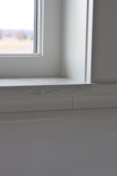 the corner of a window sill with white paint on it