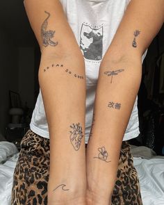 two people with tattoos on their arms and legs