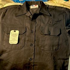 Great Timeless Retro Find. Beautiful Black Uniform Shirt From Flying Cross. Flying Cross Has Been Supplying Apparel To Several Branches Of The Armed Services Since The 1800s. Prized For Their Durability, Comfort, And Quality Of Design And Construction, They Are The Go-To Shirts For Public Safety Professionals Such As Police, Fire, Emts, Security Guards, Postal Workers, Airline Employees, Etc. You Will Look Neat And Professional While Being Stylish And Comfortable In This Never-Worn Shirt. Beauti Fitted Short Sleeve Black Shirt With Buttons, Fitted Black Tops With Pockets, Fitted Black Button-up Short Sleeve Shirt, Fitted Black Short Sleeve Button-up Shirt, Vintage Black Shirt For Fall, Vintage Black Shirt With Button Closure, Vintage Black Buttoned Tops, Classic Fitted Black Short Sleeve Shirt, Fitted Black Shirt With Pockets