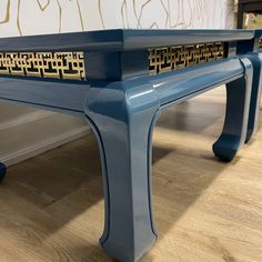 a blue bench sitting on top of a hard wood floor