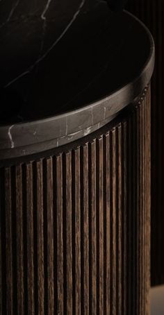 a close up of a black marble top on a wooden table