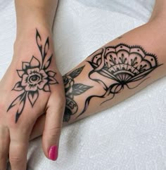 a woman's hand with tattoos on it