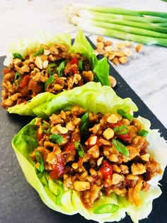 two lettuce wraps filled with meat and vegetables