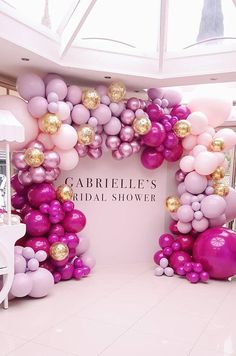 balloon arch with gold and pink balloons in the shape of an arch for a bridal shower