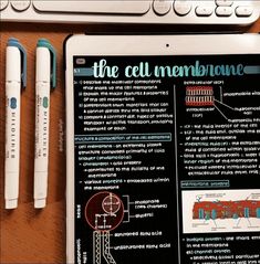 a tablet with an info sheet on it next to two pens and a computer keyboard