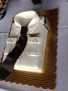 a white shirt and tie cake on a table