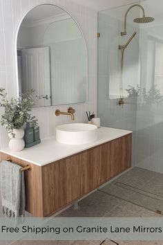 a bathroom with a sink, mirror and shower