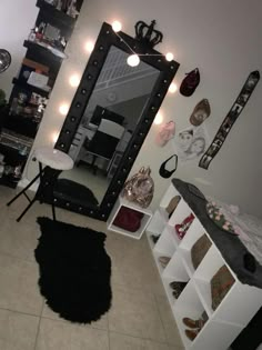 a room with a mirror, shelves and lights