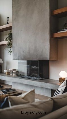 a living room filled with furniture and a fire place next to a wall mounted fireplace