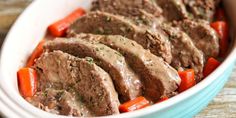 meat and carrots in a bowl with gravy on the top, ready to be eaten