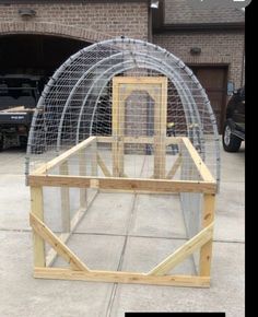 a large bird cage sitting on top of a sidewalk