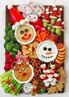 a platter filled with different types of snacks and food on skewered sticks