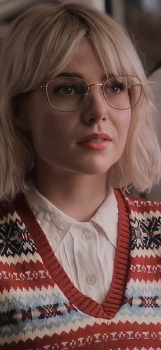 a woman with blonde hair wearing glasses and a sweater in the movie american hunk